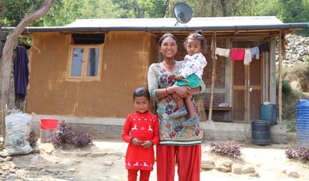 Niru & her family outside their new Habitat home